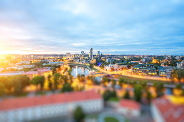 Obraz premium Vilnius cityscape view from the castle hill during the sunset in Lithuania. Wide angle photo with tilt-shift technic