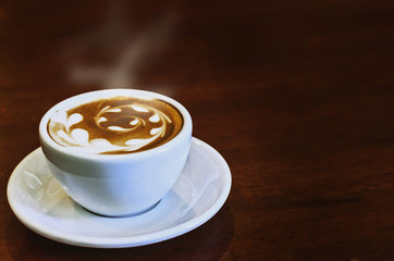 warm cup of coffee on brown background