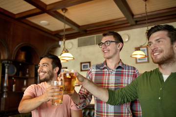 happy male friends drinking beer at bar or pub