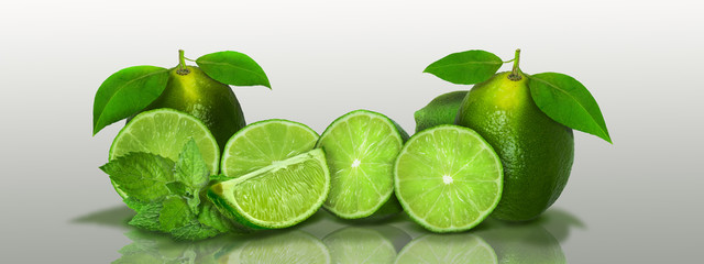 Sliced and whole limes in a panoramic - 125711113