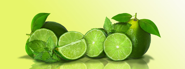Sliced and whole limes in a panoramic  - 125711157