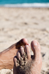 men playing footsie on the beach