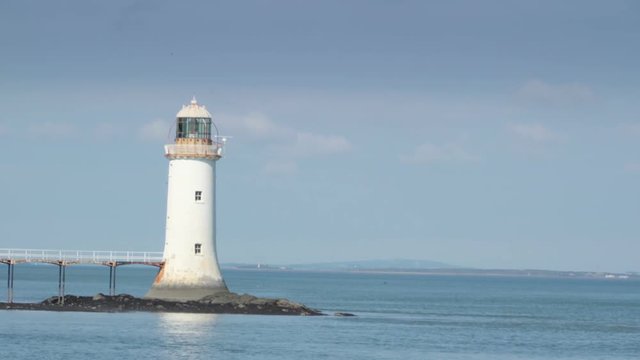 White small lighthouse in the river in Killimer Ireland.  It is located on the northern bank of the Shannon and the N67 which passes through the village.