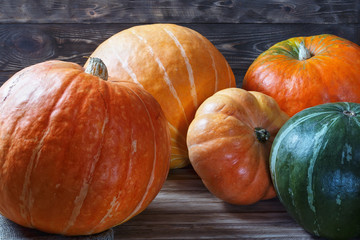Ripe pumpkins on a wooden table.