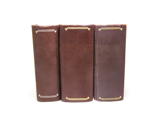 Three brown books isolated on white background