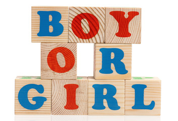 Boy or girl words formed by colorful wooden alphabet blocks, isolated on white background 