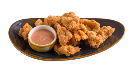 Fried chicken with sauce in plate on white background