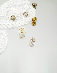 Shimmering glass beads and vintage lace on mirror background