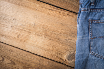 Fototapeta na wymiar jeans on wooden background