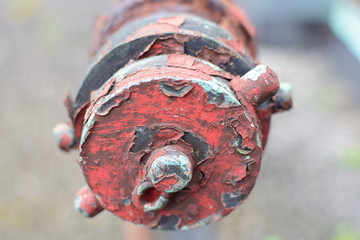 Old Rusty Drainage Pipe with Peeled Red Paint 