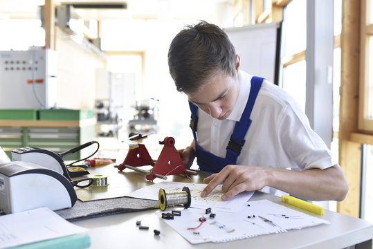 Student assembling circuit board