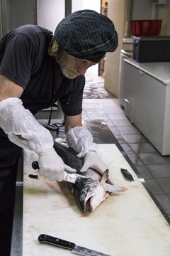 Fish smoker preparing salmon for smoking