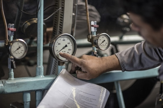 Man checking pressure on machine