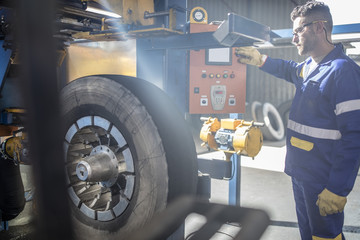 Repairman tuning tire with machine