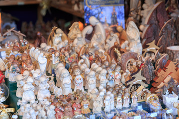 Colorful close up details of christmas fair market. Different figures decorations for sales. Angels