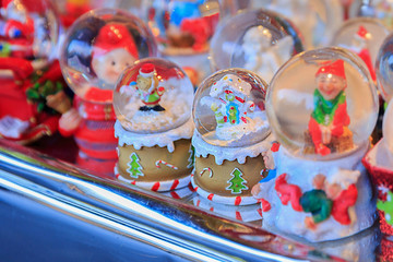 Fototapeta na wymiar Colorful close up details of christmas fair market. Snowball decorations for sales