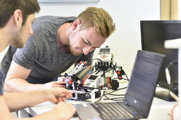 Robotics students with laptop