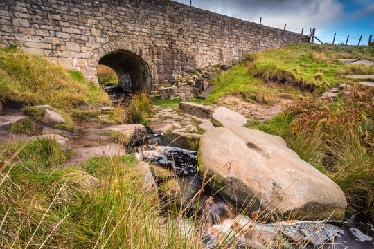 Upper Burbage Bridge east, with Burbage Brook flowing under it, in the Peak District National Park