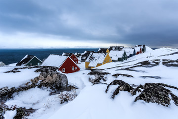 Frozen Inuit houses covered in snow. Nuuk, Greenland