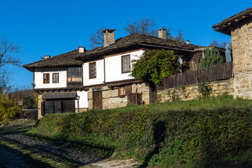 Fototapeta na wymiar Old houses and street in village of Bozhentsi, Gabrovo region, Bulgaria