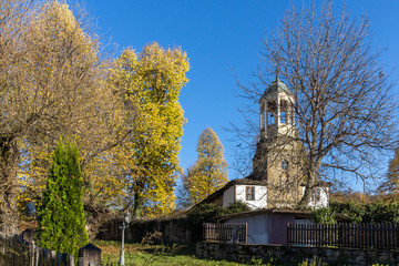 Obraz premium Autumn trees and Church of Saint Prophet Elijah in village of Bozhentsi, Gabrovo region, Bulgaria