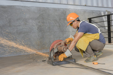 Industrial worker cutting metal with many sharp sparks - Workers