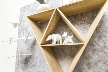 Fototapeta na wymiar Triangle shelf with paper animals - Hipster design
