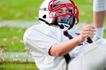 Fototapeta premium American football boy on ground