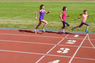 Fototapeta premium Family sport, mother and kids running on stadium track, training and children fitness concept 