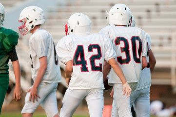 Youth football players during a game.