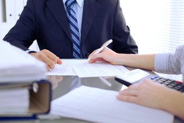 Bookkeepers or financial inspector making report, calculating or checking balance. Audit concept.