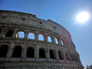 Roman coliseum exterior with shining sun