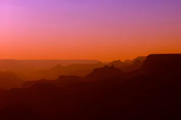 Fotobehang Baksteen Panoramic View of Grand Canyon in red and purple colors after sunset  © Michael Urmann