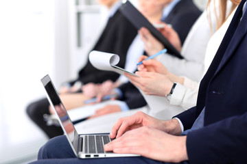 Close-up of business man hands typing on laptop computer at the conference