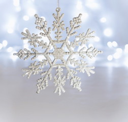 White snowflake decoration on bokeh background