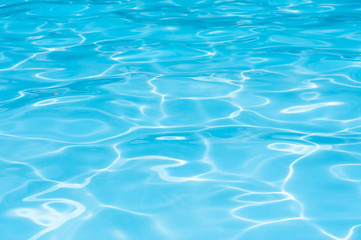 Naklejka na ściany i meble Blue water in swimming pool witn sun reflection