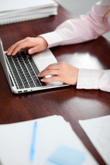 Fototapeta premium Close up of business woman hands typing on laptop computer