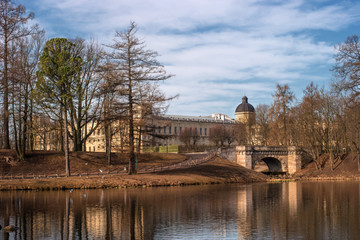 Fototapeta na wymiar Gatchina Palace. View of the Palace and Karpin bridge from the White Lake.