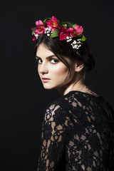 Beautiful woman with flower rim on head in lace dress