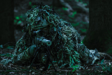 sniper wearing ghillie suit