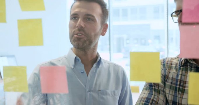 Two businessmen brainstorming new ideas at the office