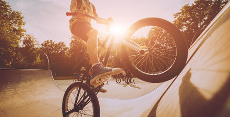 Boy riding a bmx in a park.
