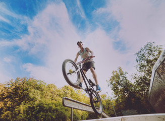 Boy jumping with his bmx in the park.