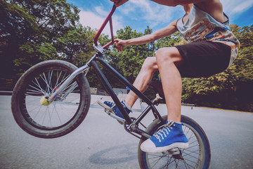 Boy jumping with his bmx in the park.