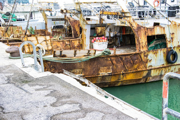 Fototapeta na wymiar Liguria Italy - Old trawler fishing boats with fishing equipment docked in port - Lerici, La Spezia, Liguria, Italy.