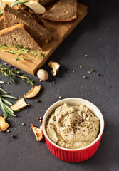 Mushroom pate on a black background, vertical, selective focus