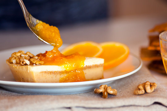 Sweet piece of cake spreaded with tasty orange jam
