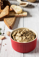 Mushroom pate on a white wooden background, vertical, selective focus
