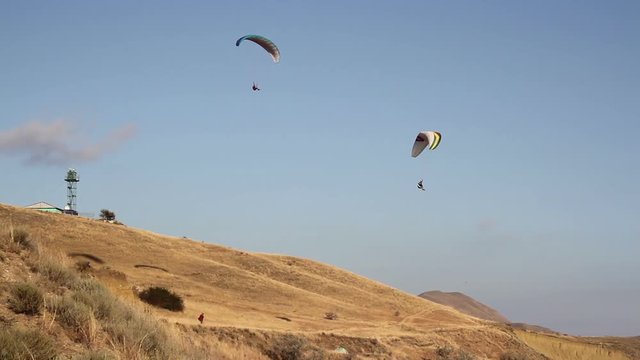Two paraglider above the bay