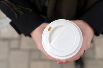 Young girl with a plastic cup of coffee